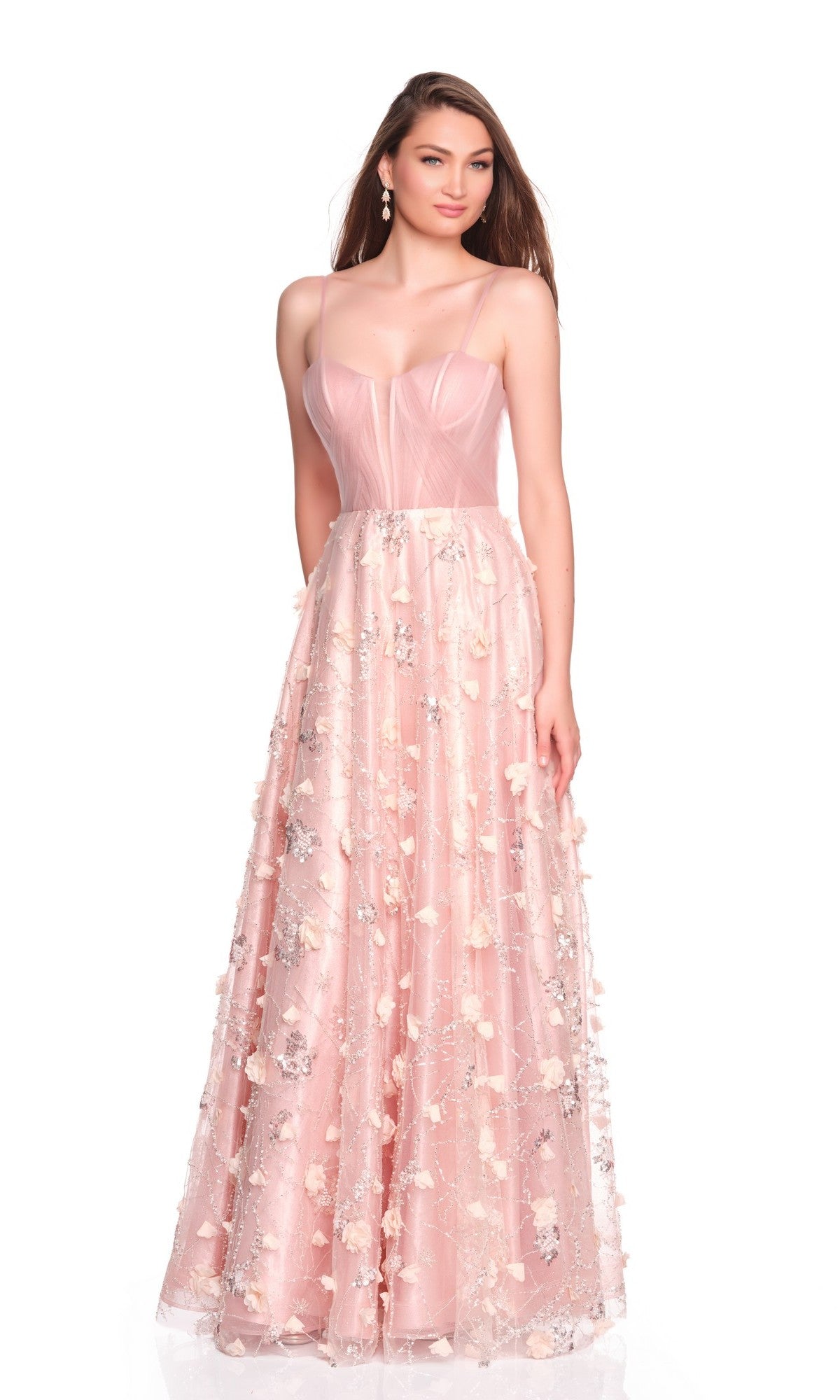 A woman faces forward, wearing the Dave and Johnny 12700 long prom dress with a corset bodice and a light-pink sheer skirt adorned with delicate 3D floral appliques.
